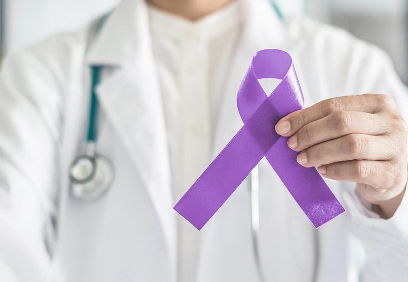 Man-holding-purple-ribbon-for-cancer-awareness